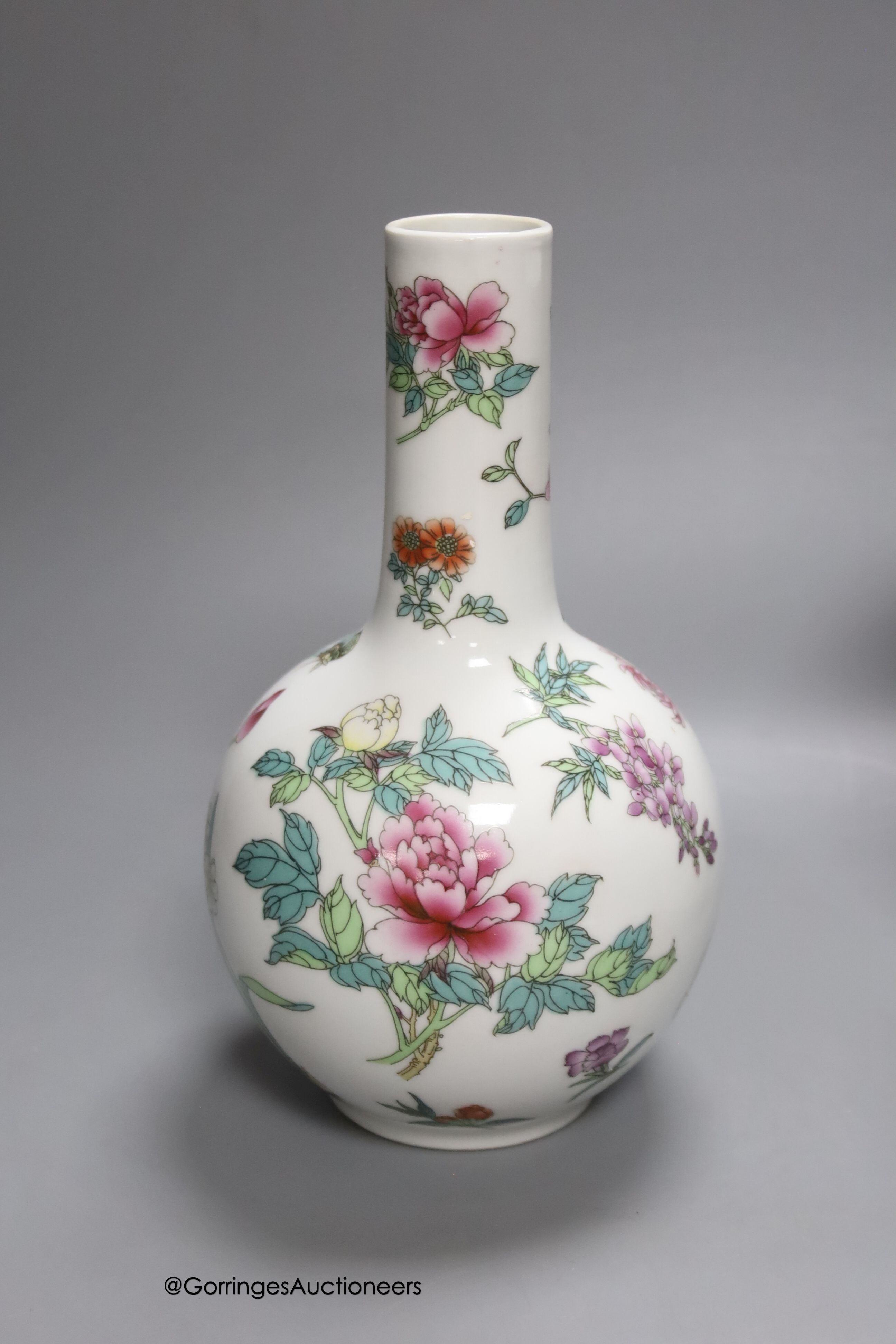 A Chinese famille rose bottle vase and a similar jar and cover and two celadon glazed vases, tallest 24cm